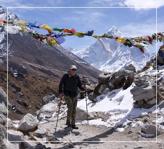 A man is standing on the side of a mountain