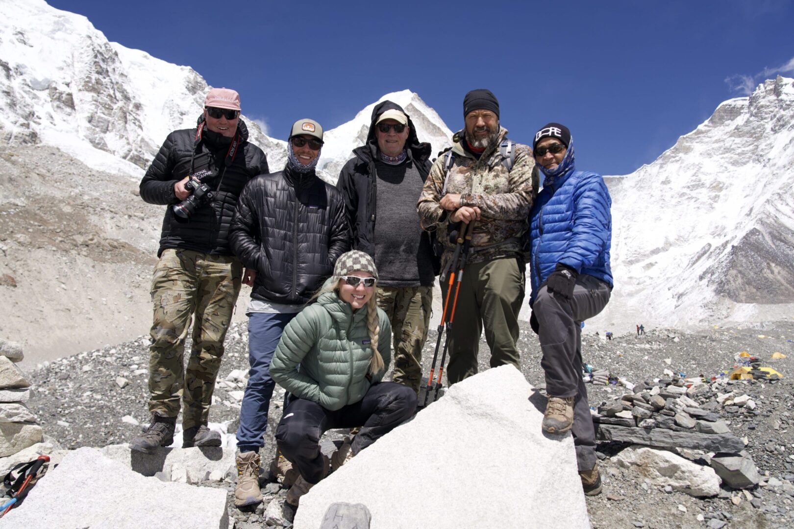 A group of people standing on top of a mountain.