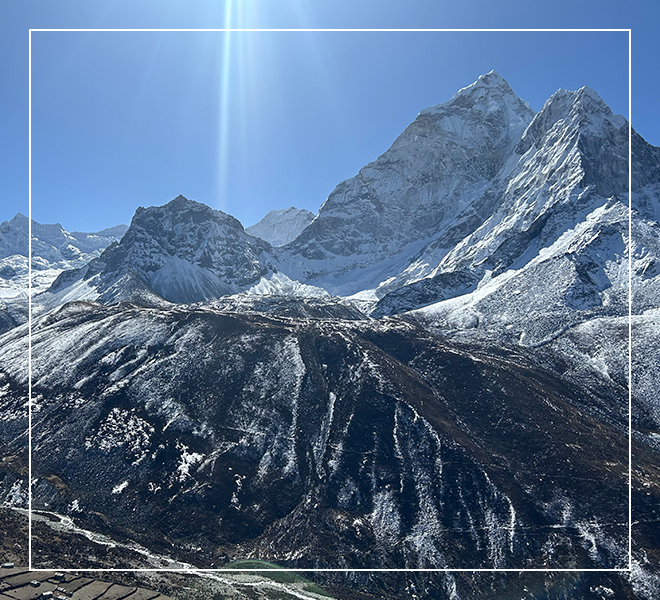 A mountain range with snow on it's sides.