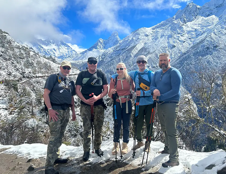 A group of people standing on top of a mountain.