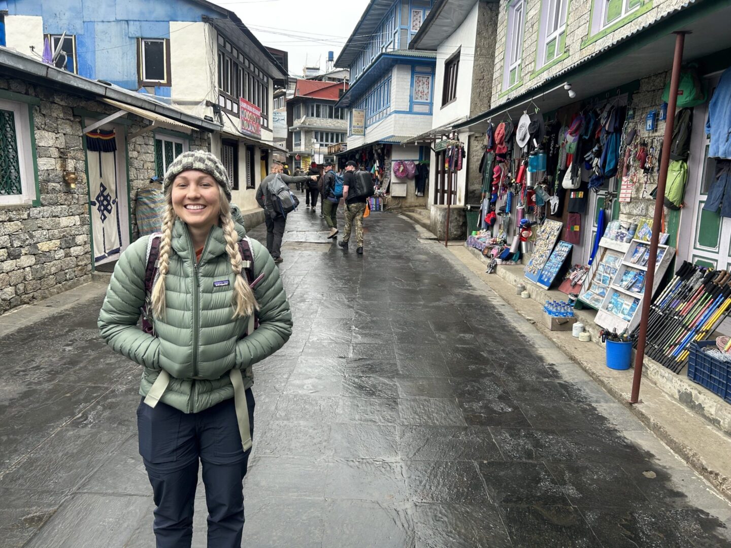 A woman standing on the side of a street.