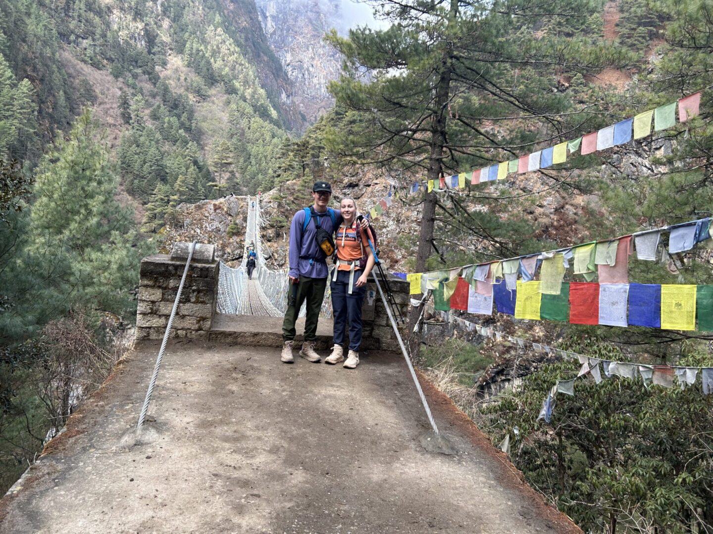 A man and woman standing on the side of a road.