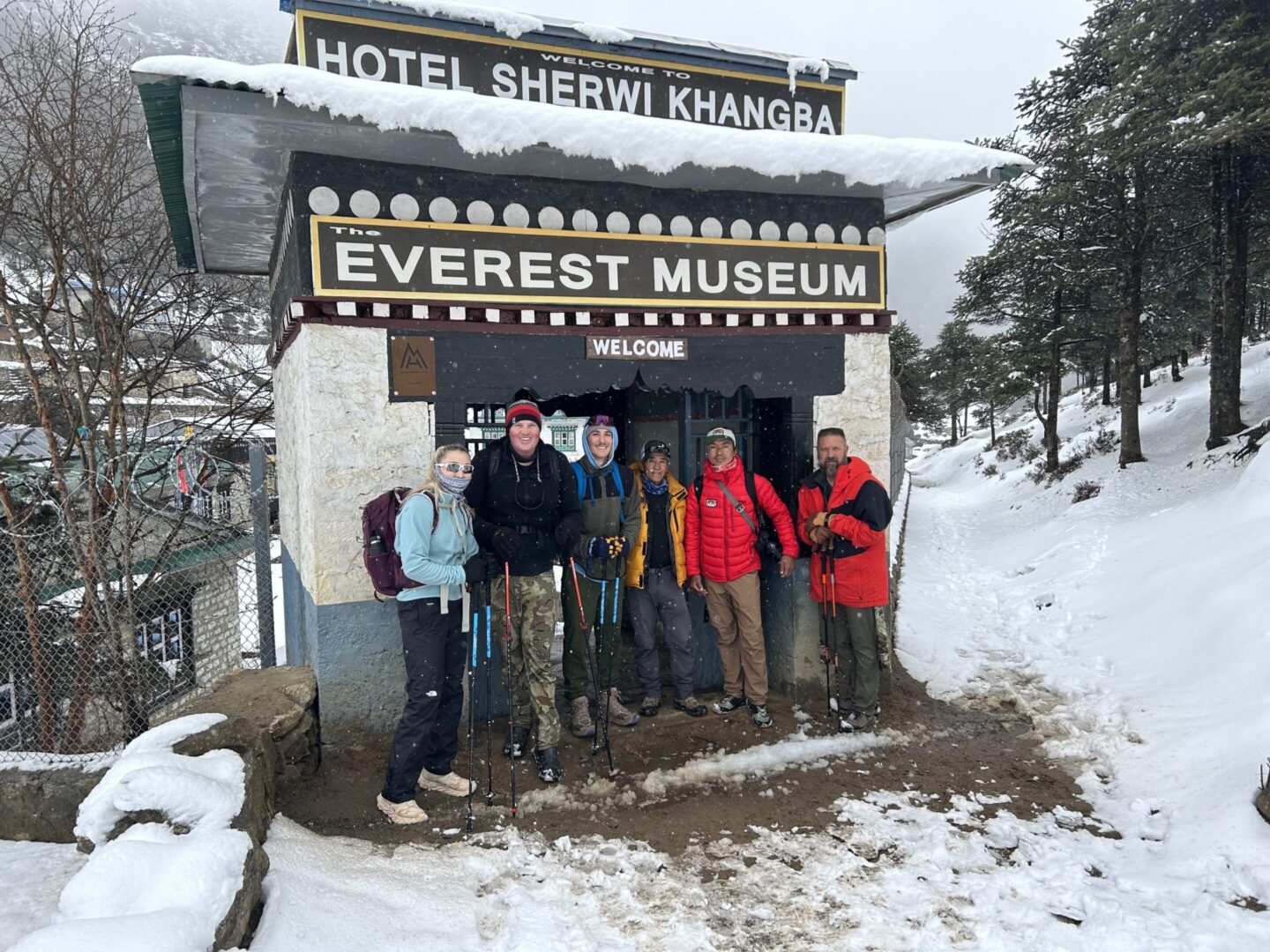 A group of people standing in front of an everest museum.